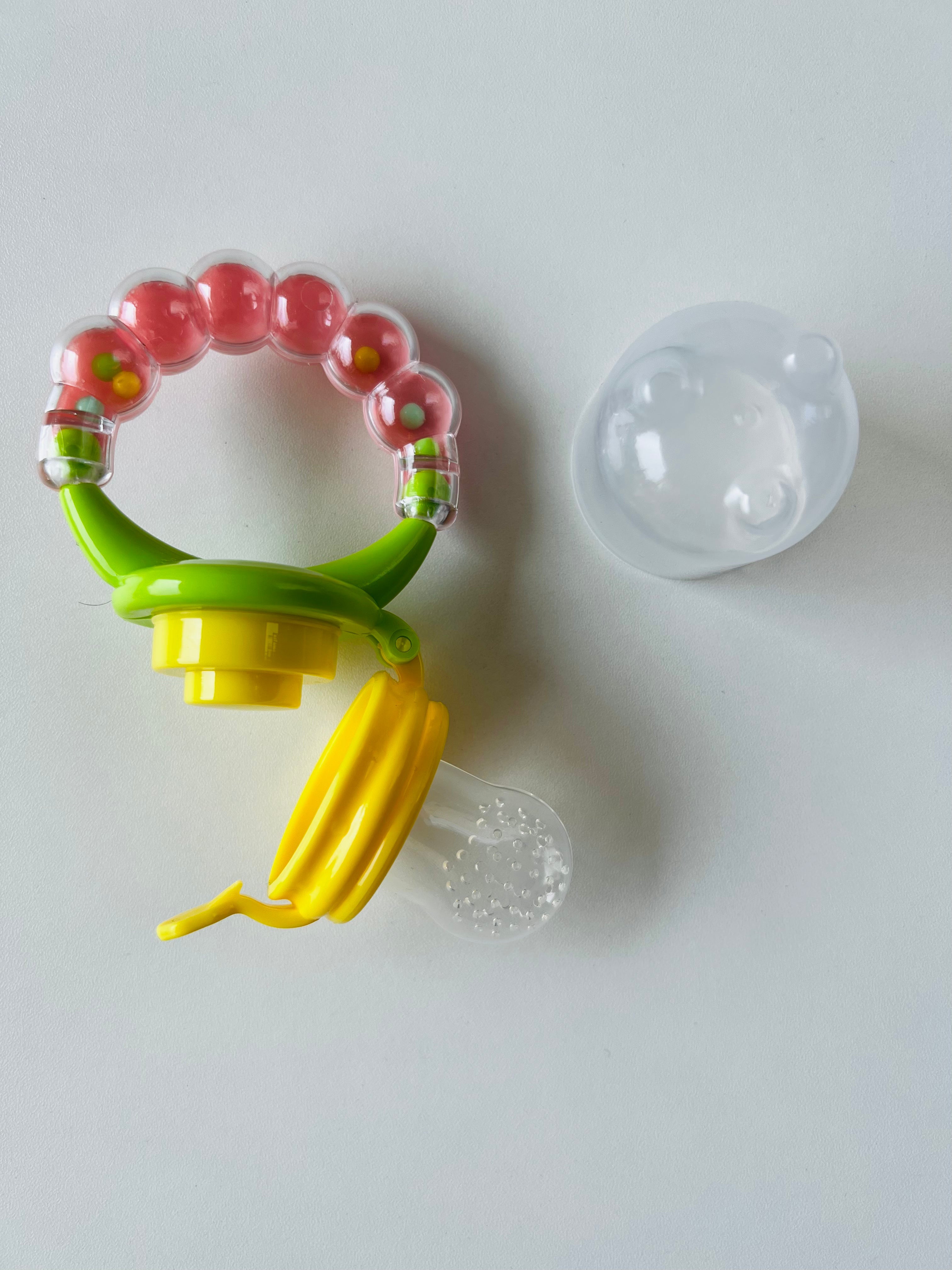 Fruit soother with rattle